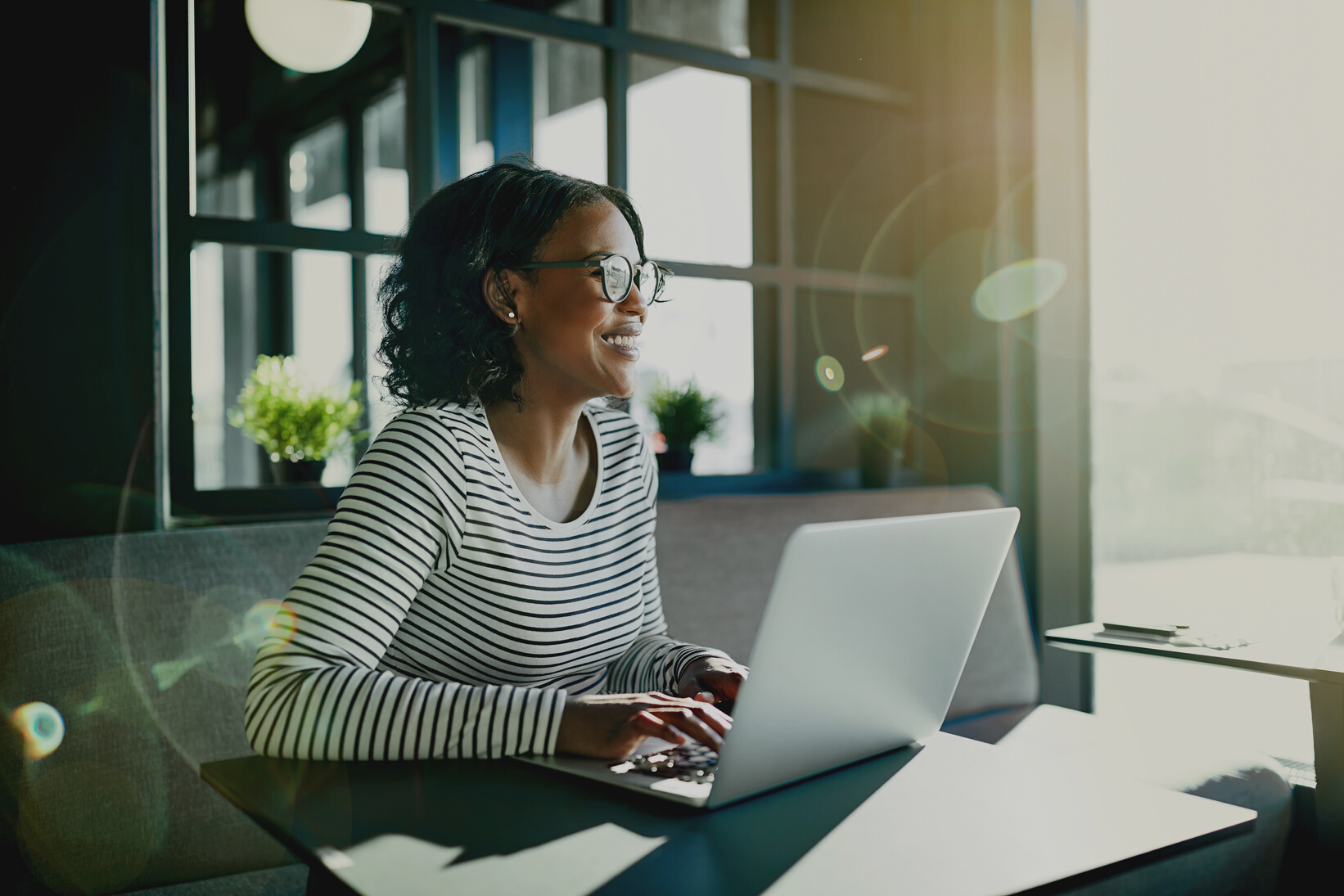 Smiling Woman Working Online with Her Laptop